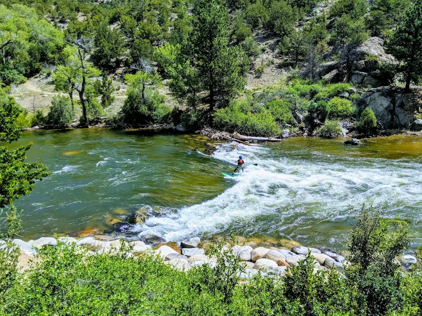 River surfer riding a wave at Buena Vista Whitewater Park in Colorado